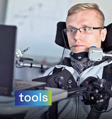 Man with a physical disability using an assisted control system to navigate on his computer. Overlaid text: "tools".